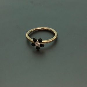 Gold ring with black flower